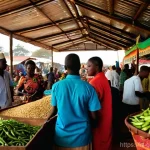 감비아 바칼롱 시장 탐방 - **Prompt:** "A bustling and vibrant open-air market in Gambia, filled with a kaleidoscope of warm, e...
